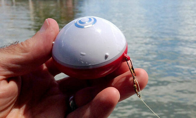 ReelSonar iBobber sonar in hand near river